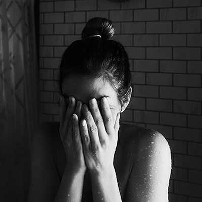 Loss-and-Trauma-Treatment person with head in hands with anxiety postpartum